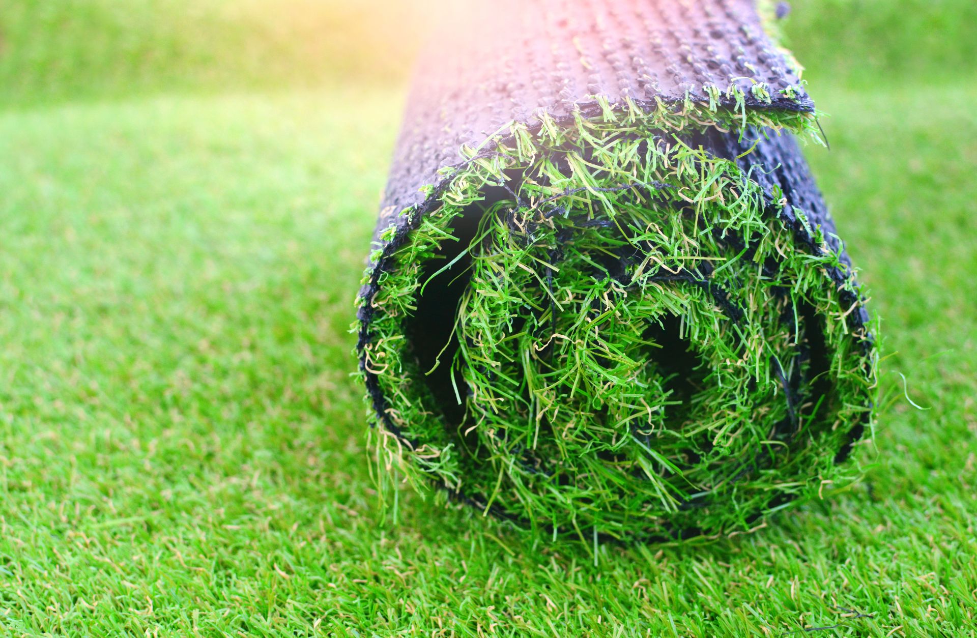 a roll of artificial grass on the ground covered by turf